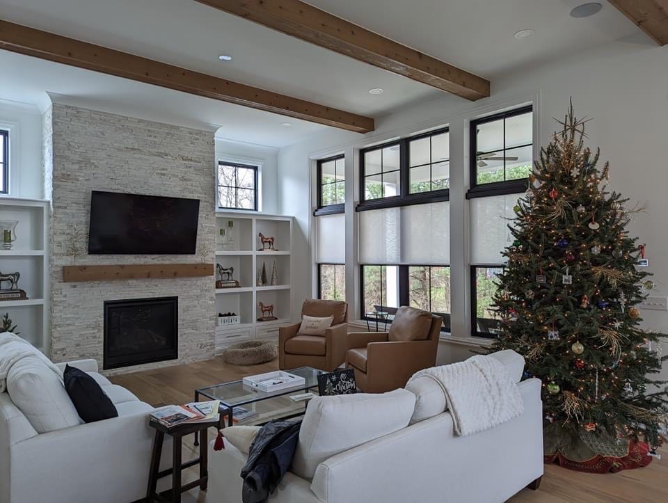 Bartlett Blinds custom solar shades installed on three large interior windows in a living room.