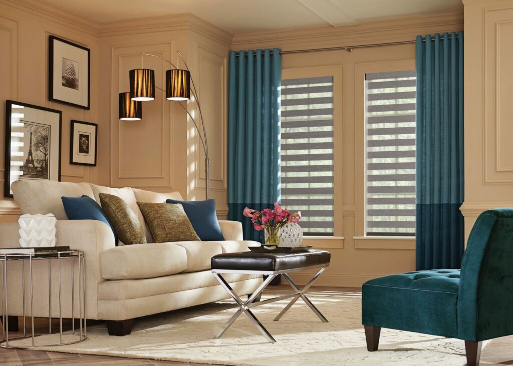 A furnished living room with layered solar shades and custom drapes, adding depth and dimension to the space.