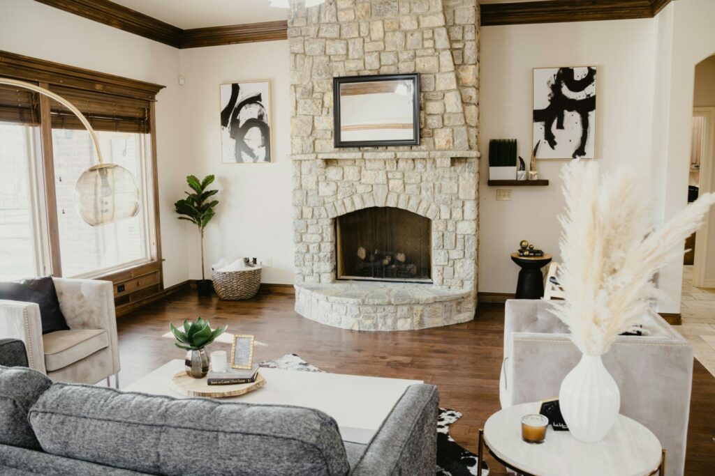 Living room with fireplace and wooden blinds.