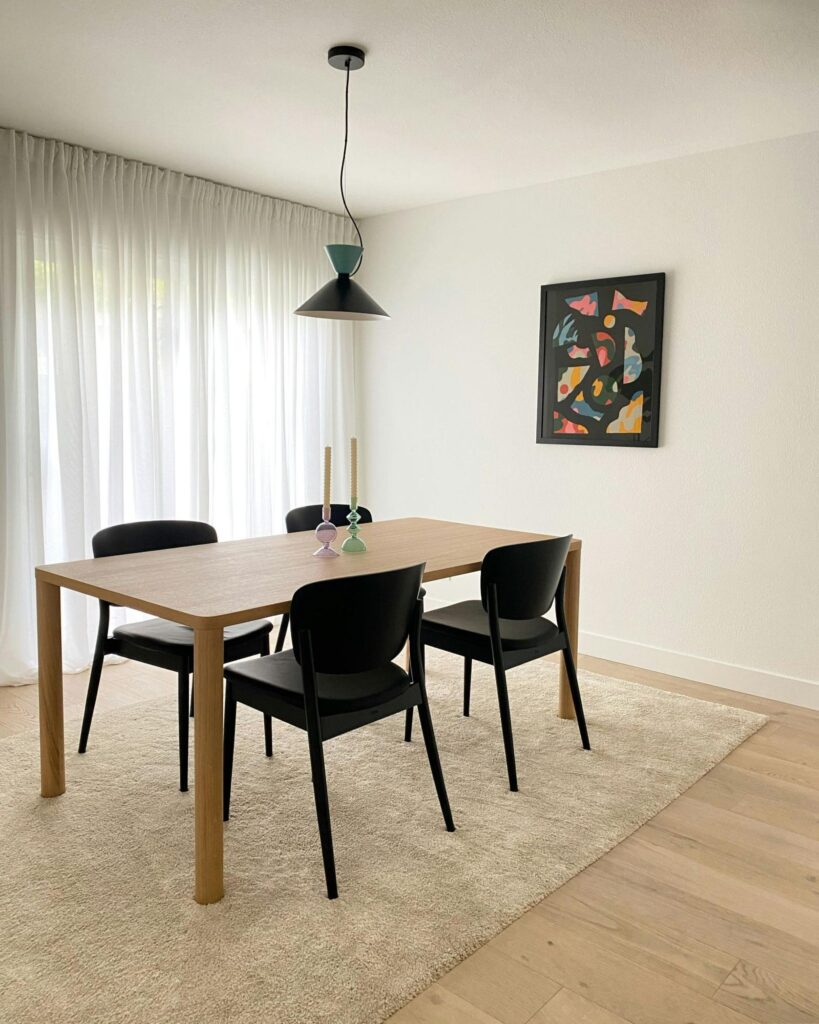 Furnished dining room with floor curtains.